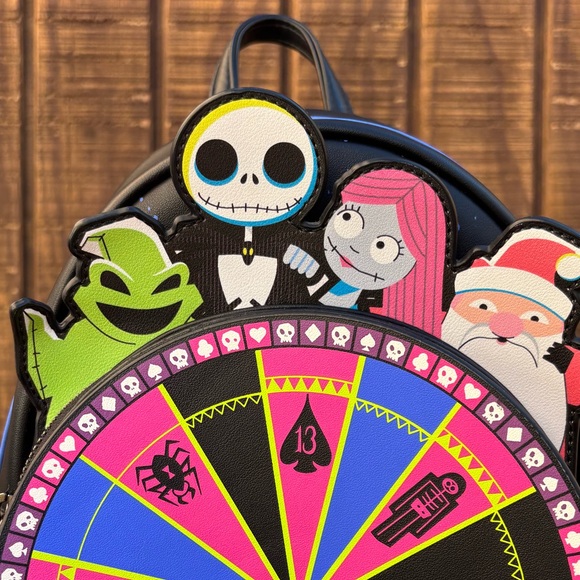 disney the nightmare before christmas oogie boogie wheel mini backpack Grotto Treasures Exclusive The fluorescent print glows under blacklight RARE! Loungefly Oogie Boogie Wheel